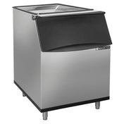 A stainless steel ice storage bin with a black, slanted front door and four metal legs. The unit has a clear, hinged top lid, 470 lbs ice capacity, and is labeled MAXX ICE on the front—sleek and functional for restaurant or bar use.