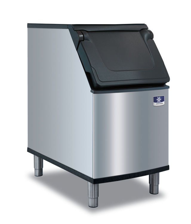 A stainless steel commercial ice bin with a Duratech exterior and four metal legs features a black plastic, top-hinged lid. The front displays a small blue and white manufacturer’s logo near the top right corner, shown against a plain white background.