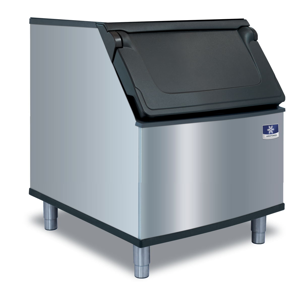A commercial Manitowoc stainless steel ice bin with a black, slanted hinged lid on top, mounted on four metal legs. The shiny bin features a small manufacturer logo on the front. Perfect for use with a top-mounted ice maker. Background is plain light gray.