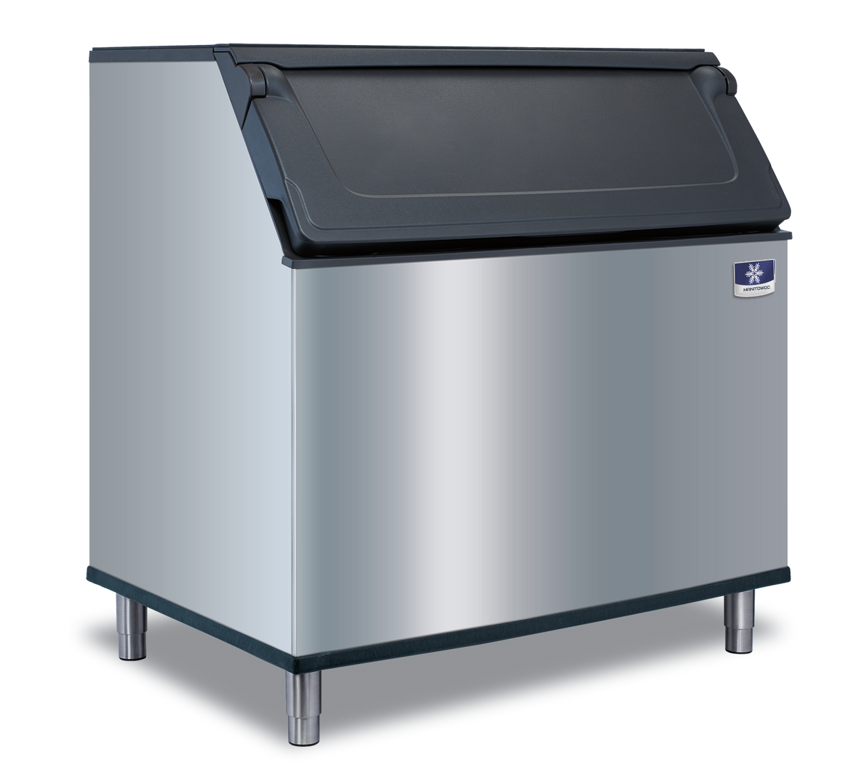 A commercial stainless steel Manitowoc ice bin with a black hinged lid stands on four metal legs against a plain white background. The front features a small blue and white manufacturer’s badge in the upper right corner, ready for a top-mounted ice maker.