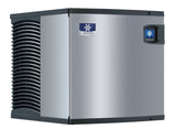 A large Manitowoc Indigo NXT commercial ice maker with a vented black side panel, blue rectangular control display, and a logo featuring a white snowflake and the brand name “MANITOWOC” on the front.