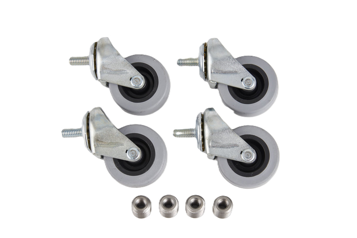 Four gray 2.5 inch swivel Manitowoc casters with metal brackets are arranged in a square pattern. Below the wheels, four matching metal threaded inserts are lined up in a row, all items placed on a white background.