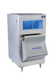 A stainless steel Manitowoc LB0730 with a front blue-lit window and an open gray ice storage bin below, angled outward. The machine stands on four metal legs and features a sleek, modern design against a white background.