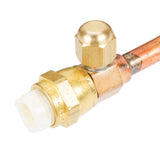 A close-up of a brass refrigerator access valve attached to a Manitowoc Remote Tubing Kit. The valve features a hexagonal cap and a white plastic connector, perfect for servicing refrigeration systems with 20 ft. tubing. The metal surfaces are shiny and clean.
