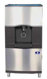 A stainless steel commercial Vending Ice Dispenser with a black panel, push button, and dispensing area. It features a drip tray, blue-and-white manufacturer label, vertical black ridges, and is ideal for ice bucket filling in busy environments.