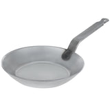 Top-angled view of the Matfer Bourgeat 062001 black steel fry pan, highlighting the wide cooking surface and riveted handle suitable for high-heat stovetops.