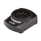 A black, rectangular single charger cradle with a circular slot in the center, designed for the Waring MXECHG1. Three metal charging contacts are inside the slot, and a logo with text is printed on the front left side of the cradle’s surface.