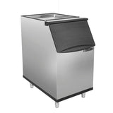 A stainless steel ice storage bin with four metal legs, a black plastic flip-up lid, and MAXX ICE branding on the front. The rectangular bin features an industrial look and pairs perfectly with your commercial ice maker setup.
