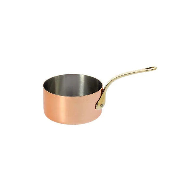 A De Buyer Copper Saucepan with high-end mirror polishing features a shiny silver interior and a long, curved brass handle attached by rivets. Empty and elegant, the pan is angled to the right against a plain white background.