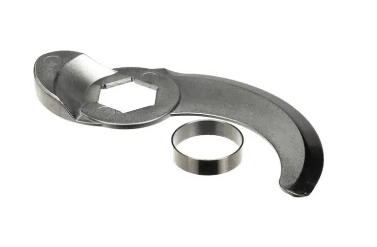 A curved, metallic spanner wrench with a smooth edge and hexagonal opening sits on a white background. Next to it is a separate, small metal ring, likely used as a washer or spacer. Both R45T items appear clean and unused.