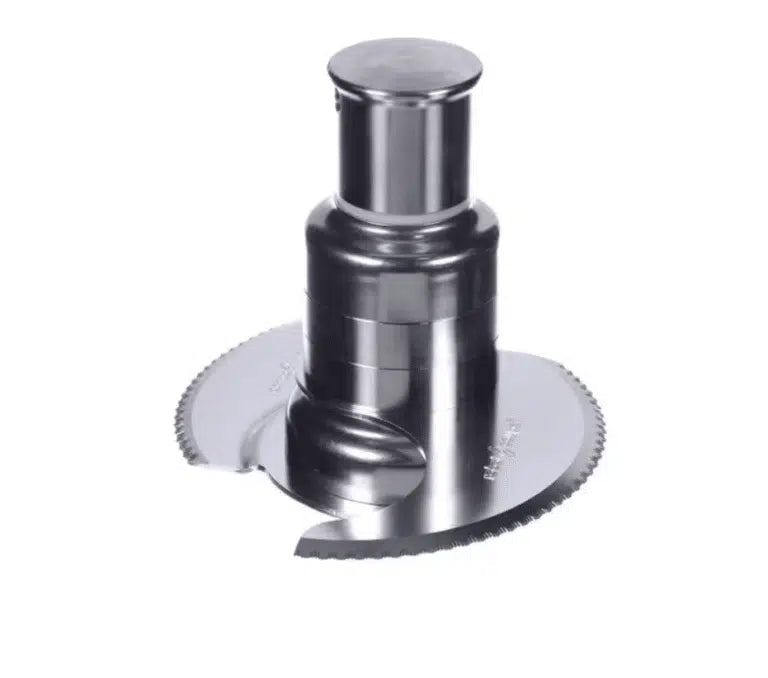 A close-up of a shiny, stainless steel S Blade food processor attachment with two curved, fine serrated edge blades, positioned vertically on a white background. The blades overlap and the central shaft is cylindrical and metallic.