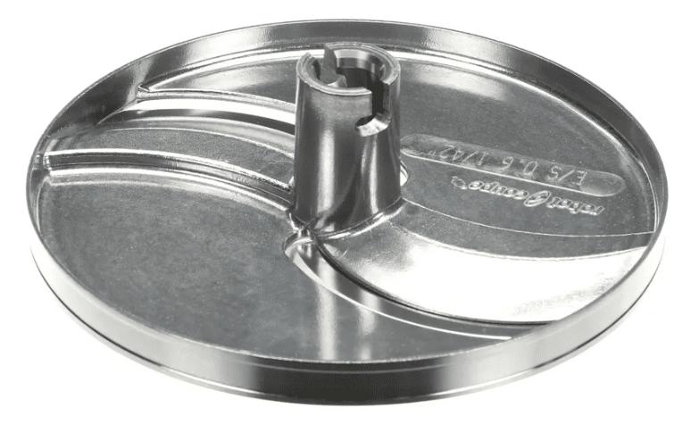 A shiny, circular 0.6mm slicing disc with a raised central hub and two curved grooves. The smooth reflective surface shows stamped lettering and numbers. Designed for use in a Robot Coupe food processor or slicer appliance.