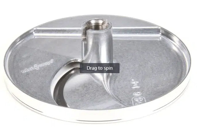 A shiny, round 6mm slicing disc compatible with Robot Coupe, featuring a stainless steel central hub and sharp curved blade. Measurement markings are etched near the edge, set on a white background. “Drag to spin” text overlays the center.