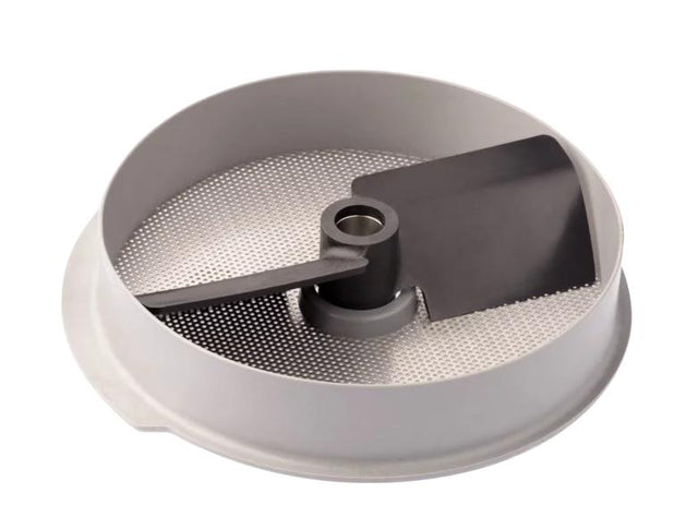 A close-up of a round, metallic Robot Coupe 3mm food mill disc with a perforated surface and a black plastic blade at the center. This Mashed Potato Attachment is designed to fit into a food processor or mill for pureeing or straining food.
