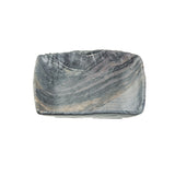 A rectangular ceramic serving tray with gently curved edges and a glossy finish, featuring a marbled pattern in shades of gray, black, and hints of beige. The plate is photographed on a plain white background.