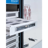 A white Accucold Drawer labeled Influenza A (H1N1) 2009 is pulled out to its full extension from a pharmacy refrigerator with adjustable dividers. Human anatomy posters are visible on the wall, and a stethoscope rests on a counter nearby. The refrigerator features an Accucold pharmaceutical storage label.