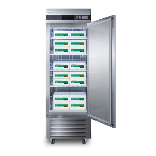 A tall, stainless steel commercial reach-in freezer with the door open, revealing multiple shelves holding stacked white boxes with green and black labels. The unit has a digital temperature display and is on wheels.