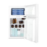 A white ADA compliant healthcare refrigerator-freezer with both doors open, showing blue gel packs in the top freezer and shelves below holding brown bottles, clear bottles, and blue solution bottles. The temperature display, NIST calibrated, shows “4.0°C.” The fridge is clean and organized.