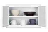 A white wall cabinet with both doors open shows white bowls, two white mugs, and three stacked gray cups on the adjustable bottom shelf. The top shelf holds one large white bowl and two stacks of flat, dark gray plates. The cabinet comes with mounting hardware for easy installation, and the background is plain white.