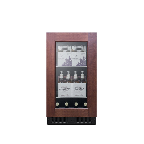 A compact, panel ready glass-front refrigerator with a dark wood frame, styled as an undercounter commercial beverage center. It’s stocked with clear glass bottles labeled “Ginger Ale” and boxed beverages, set against a plain white background.
