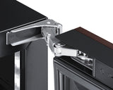 Close-up of a robust, silver hinge connecting a dark cabinet frame to a panel ready door. The door features a glass panel and dark wood trim—typical of a stylish commercial beverage center or premium undercounter unit.