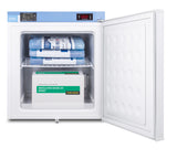 An open Accucold medical freezer displays a digital temperature of -20.3°C. Inside this NIST calibrated, compact all-freezer, blue ice packs are stacked above a cardboard box labeled “Varicella Virus Vaccine Live VARIVAX,” which sits on the lower shelf. The interior is clean and organized.