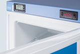 A close-up of a blue and white Accucold medical freezer with its door slightly open. Two digital displays above show the internal temperature as -20.5°C. The NIST calibrated freezer interior is empty and clean, with a bright white finish and smooth surfaces visible inside.