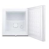 A small, white compact freezer with its door open. The interior is empty, featuring a single wire shelf and a temperature control dial on the back wall. The flat door has a textured rectangular pattern, ideal as an undercounter freezer in tight spaces.