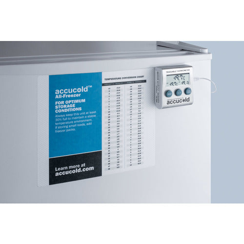 A white Accucold Undercounter Freezer door with an Accucold temperature monitoring device showing digital readings is mounted on the front. Next to it, a blue and white information sheet displays a temperature conversion chart and storage guidelines.
