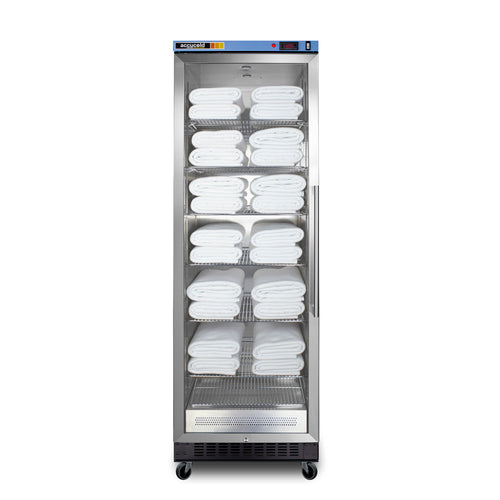 A tall, stainless steel towel warmer cabinet with a glass door shows neatly stacked, folded white towels on multiple adjustable shelves inside. The cabinet stands on four small wheels and has control buttons on the top front panel. Incorporating passive heating technology, this blanket warmer ensures your linens remain perfectly warm and ready for use.