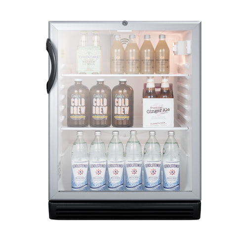 A mini fridge with a glass door acts as a sleek refrigerated merchandiser, displaying bottled drinks on three shelves: the top shelf has tan bottles, the middle holds large Cold Brew bottles and ginger ale, while the bottom showcases six clear sparkling water bottles labeled Gerolsteiner.