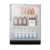 A small, ADA compliant glass-door commercial refrigerated merchandiser with three shelves holds bottles of cold brew coffee, bottles of ginger ale, and glass bottles of Gerolsteiner mineral water, all neatly arranged and well-lit against a white background.