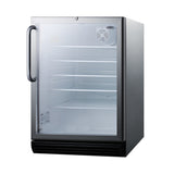 A small, stainless steel, single-door refrigerated merchandiser stands with its transparent glass door open, revealing four empty shelves inside. A fan is visible on the inner back wall. The reach-in cooler features a handle on the left and a black vent at the bottom front.