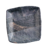 A square, shallow melamine plate with subtly rounded edges, featuring a dark barnwood pattern of black, gray, and deep brown tones for a wood-like texture. The slightly glossy surface sits against a plain white background.
