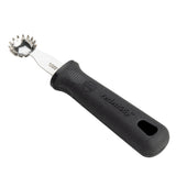 A stainless steel grapefruit spoon with a serrated, jagged edge bowl and a black ergonomic PerfectGrip handle, designed for scooping fruit or serving as a handy Tomato Stem Corer. The handle features textured grip and a hole at the end for hanging.