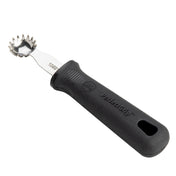 A stainless steel grapefruit spoon with a serrated, jagged edge bowl and a black ergonomic PerfectGrip handle, designed for scooping fruit or serving as a handy Tomato Stem Corer. The handle features textured grip and a hole at the end for hanging.