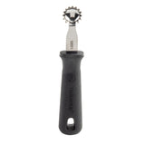 A metal pastry cutter with a jagged, round stainless steel wheel and a black handle labeled PerfectGrip. The handle features a hole for hanging and a textured grip. The tool is positioned vertically against a white background.