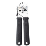A TableCraft Products PerfectGrip Can Opener is shown upright, featuring two black, textured handles embossed with PerfectGrip. This chrome plated can opener has a rotating cutting wheel, serrated gear, metal turning knob, and hanging holes.