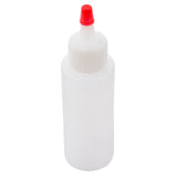 A translucent 2 oz. TableCraft Chef Squeeze Bottle with a white ribbed screw-on cap and a small red pointed nozzle for dispensing liquids. The bottle is shown upright against a white background.