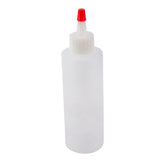 A 4 oz. Chef Squeeze Bottle by TableCraft with a clear plastic body, white twist cap, and red pointed nozzle, shown upright against a plain white background.