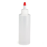 A clear, cylindrical TableCraft 4 oz. Chef Squeeze Bottle with a white screw-on cap and narrow pointed nozzle topped by a small red cap, standing empty and upright against a plain white background.