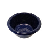 A small, round 4 oz enamelware ramekin with a wide rim, made of dark blue porcelain enamel-coated metal and dotted with white speckles. The bowl has a smooth, glossy finish and appears empty.