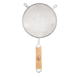 A double fine mesh strainer with a round stainless steel frame and two small support hooks, featuring a long wooden handle with a visible brand logo. The photo is taken from above against a white background.