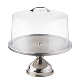 A shiny cake stand with a stainless steel base holds a round plate, covered by a clear plastic cover with a small handle on top. The stand and lid are empty, set against a plain white background.