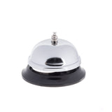 A chrome plated call bell with a round, shiny dome top and small button sits on a black base, isolated on a white background. This TableCraft bell is typically used at hotel reception desks or counters to attract attention.