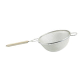 A tinned metal mesh strainer with double fine mesh netting, a round bowl shape, a long handle with a light wooden grip, and a small metal support handle on the opposite side, isolated on a white background.