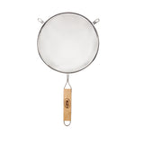 A metal strainer with a round, medium mesh frame and two small support hooks. It features a long wooden handle with metal edges, a hanging loop, and a logo. The background is plain white.