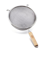 A fine mesh strainer with a round silver frame, two support hooks, and a wooden handle engraved with text is shown isolated on a white background. The strainer is angled to display its smooth construction.
