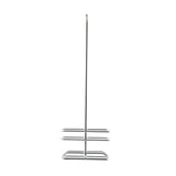 A tall, freestanding TableCraft metal toilet paper holder with a vertical pole and two horizontal tiers at the base for holding multiple rolls. This rack only features a minimalist, chrome plated finish and open design, standing upright against a plain white background.