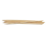 A small pile of TableCraft bamboo skewers lies on a white background. The 10 inch skewers are thin, cylindrical, light beige in color, and have sharp pointed tips for grilling or holding together pieces of food.
